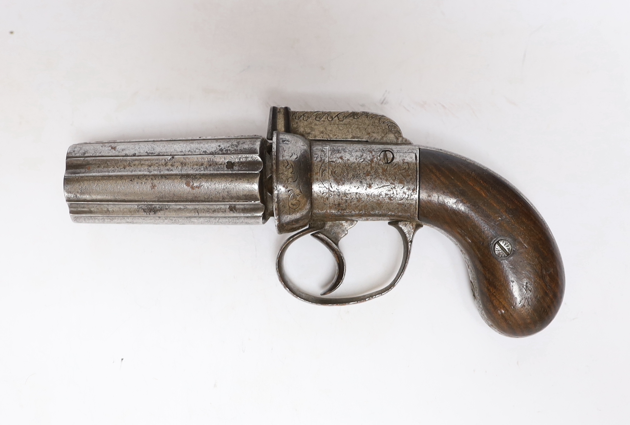 A mid-19th century six shot self-cocking percussion pepper box revolver, with foliate engraved frame, fluted barrels and two piece walnut grips, barrel 7.5cm